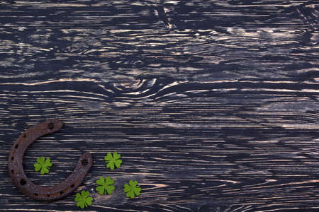 Fabric green clover leaves with horseshoe on dark wooden background.の写真素材