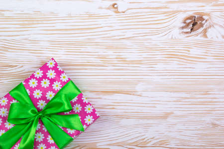 Gift box with ribbon on white wooden tableの写真素材