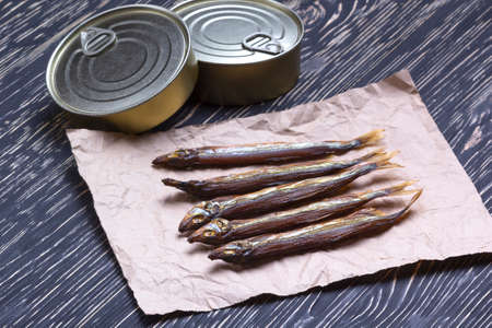 Smoked capelin and conserve tins on dark wooden backgroundの写真素材