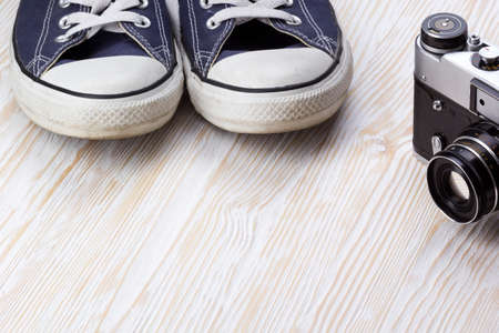 Travel still life with sneakers and camera  on wooden backgroundの写真素材