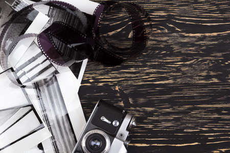 retro camera and some old photos on wooden tableの写真素材