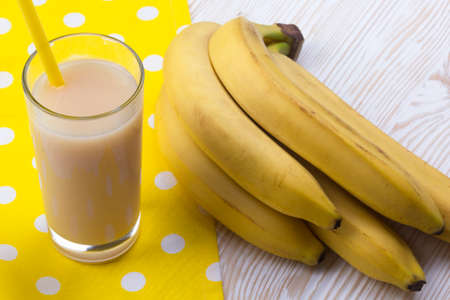 Banana juice with bananas on the wooden backgroundの写真素材