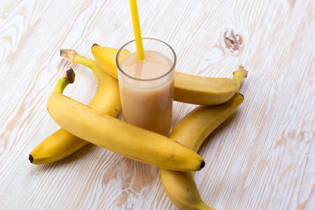 Banana juice with bananas on the wooden backgroundの写真素材