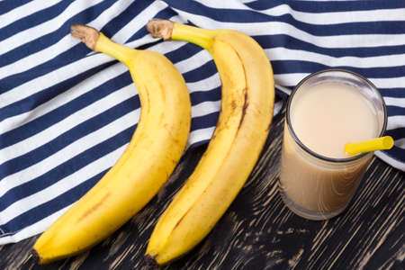 Banana juice with bananas on the wooden backgroundの写真素材