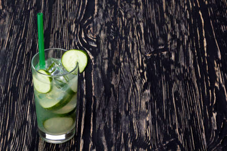 Summer cucumber cocktail , drink with fresh vegetable on wooden background.