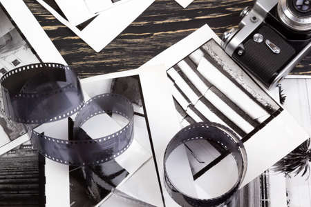 retro camera and some old photos on wooden tableの写真素材