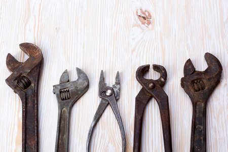 vintage pliers, adjustable wrench on wooden tableの写真素材