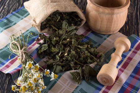 mortar and pestle with herbal tea on wooden background.の写真素材