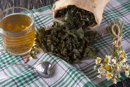 herbal tea with chamomile on a wooden tableの写真素材