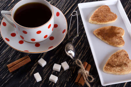 Cup of tea with cinnamon cookies on wooden background.の写真素材