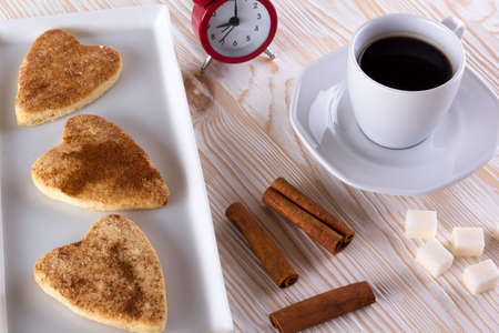Cup of coffee with cinnamon cookies on wooden background.の写真素材