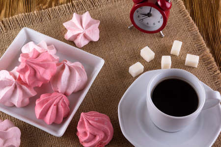 Meringue Cookies and cup of coffee on wooden background.の写真素材