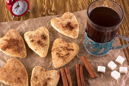 Glass of tea with cinnamon cookies on wooden background.の写真素材