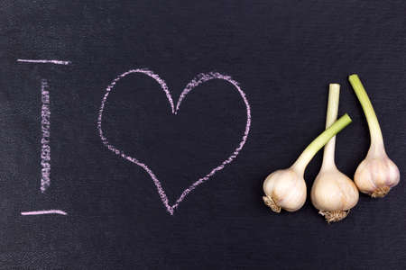 Ground with i love text and garlicon the black background.の写真素材