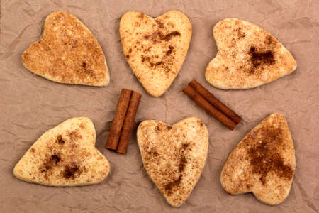 Cookies and cinnamon sticks on crumpled paper, top viewの写真素材