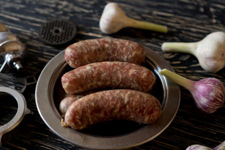 raw sausages , garlic and old meat grinder partsの写真素材
