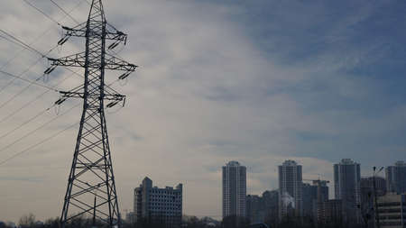 Cityscape at dusk including a large power line.の写真素材