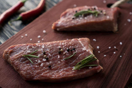 fresh beef meat on cutting Board on wooden backgroundの写真素材