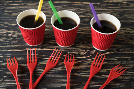 Cups with drink and red forks.の写真素材