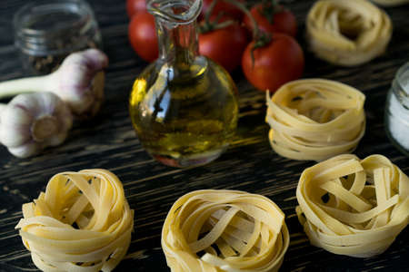 Pasta ingridients and spice on wooden surface.の写真素材