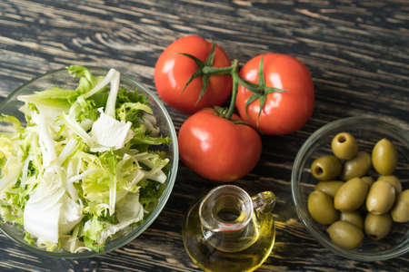 Salad leaves with olives, tomato and oil.の写真素材