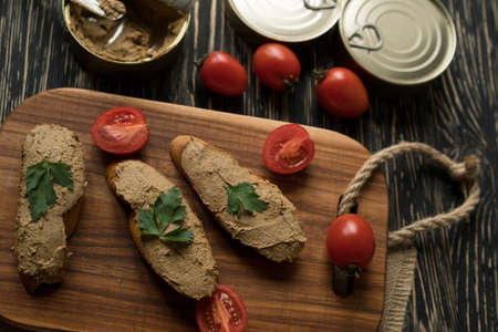 Liver pate on the bread on wooden tray.の写真素材