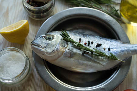 Raw fish cooking and ingredients. Dorado, lemon, herbs and spices.の写真素材
