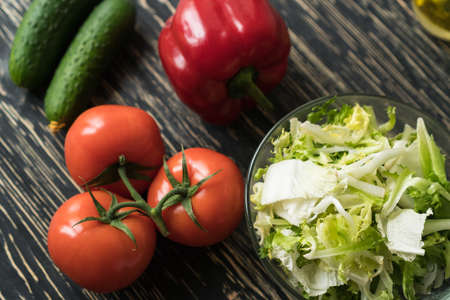 Healthy veggie salad ingridients. Tomato lettuce, paprika and cucumber.