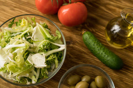 Salad ingridients. Tomato, lettuce, cucumber and olive oil.の写真素材