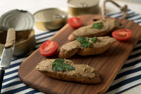 Liver pate on the bread on wooden tray.の写真素材