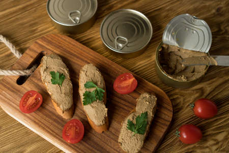 Liver pate on the bread on wooden tray.の写真素材
