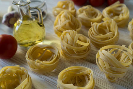 Pasta ingridients and spice on wooden surface.の写真素材