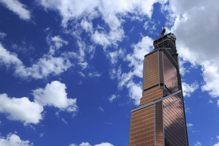 Modern skyscraper under constuction against blue sky  