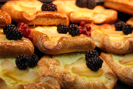 Closeup of fresh baked pastry pies with fruits and berries.の写真素材