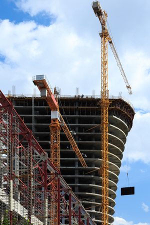 Two cranes at the construction site of high-rise building.の写真素材