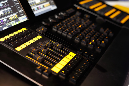 Closeup of lighting desk used in lighting design to control stage lights. Selective focus.の写真素材