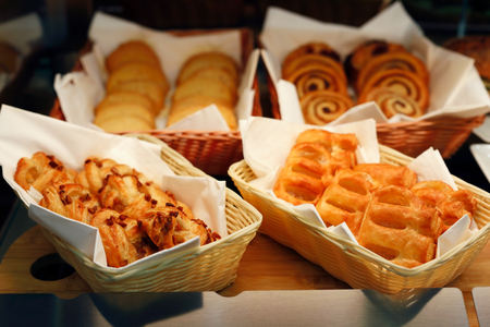 Pastry bakery display with assorted buns and jam puffs.の写真素材