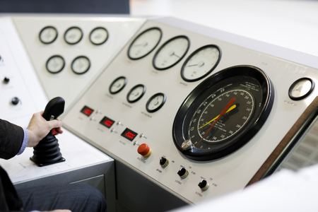 An engineer working at the remote control console of petroleum drilling rig. Selective focus.の写真素材