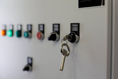 Industrial electrical control cabinet with lamps, switches, and keys. Selective focus.の写真素材