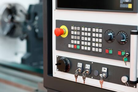 Modern turning machine with CNC control panel in the foreground. Selective focus.の写真素材
