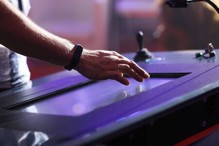 Operator using touch screen to control industrial equipment. Selective focus.