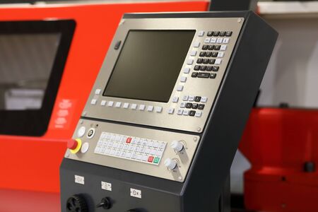 CNC machining center and a control panel. Selective focus.