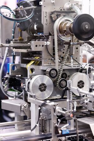Detail view of a pharmaceutical packaging machine. Selective focus.