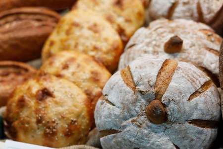 Different types of bread on the bakery shelf. Selective focus.