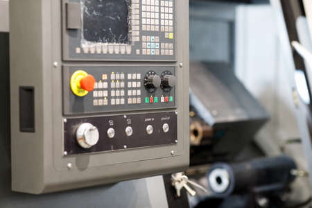 Metalworking lathe machine with CNC control panel. Selective focus.