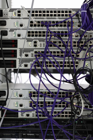 Telecommunication rack with switches, gateways and patch cords.
