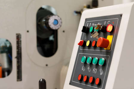Buttons and switches on the control panel of modern industrial machine. Selective focus.