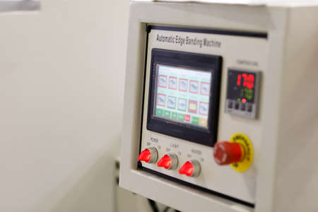 Control panel of automatic edge banding machine. Selective focus.