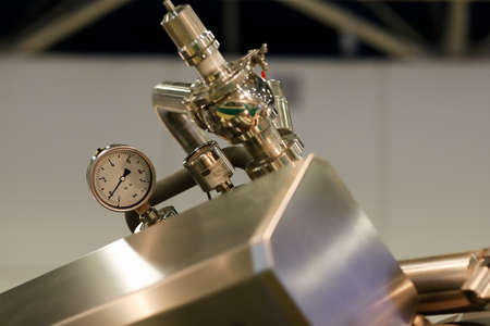 Pressure gauge on stainless steel equipment in a food factory. Pressure gauge in hygienic design for...