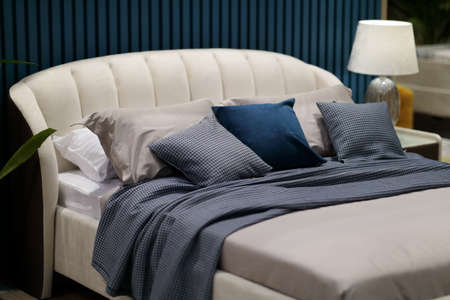 Bedroom with pillows and cushions on a double bed. Selective focus.の写真素材